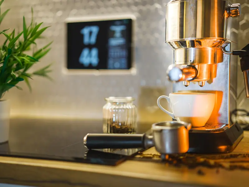 Espresso machine setup with coffee beans and mug on countertop, ideal for home baristas